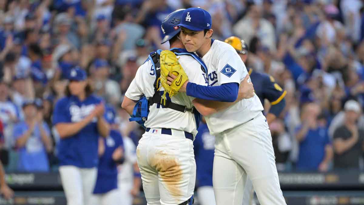 Los Angeles Dodgers catcher Will Smith (16) and pitcher Roki Sasaki (11) celebrate after defeating the Milwaukee Brewers in game three of the NLCS round for the 2025 MLB playoffs at Dodger Stadium.