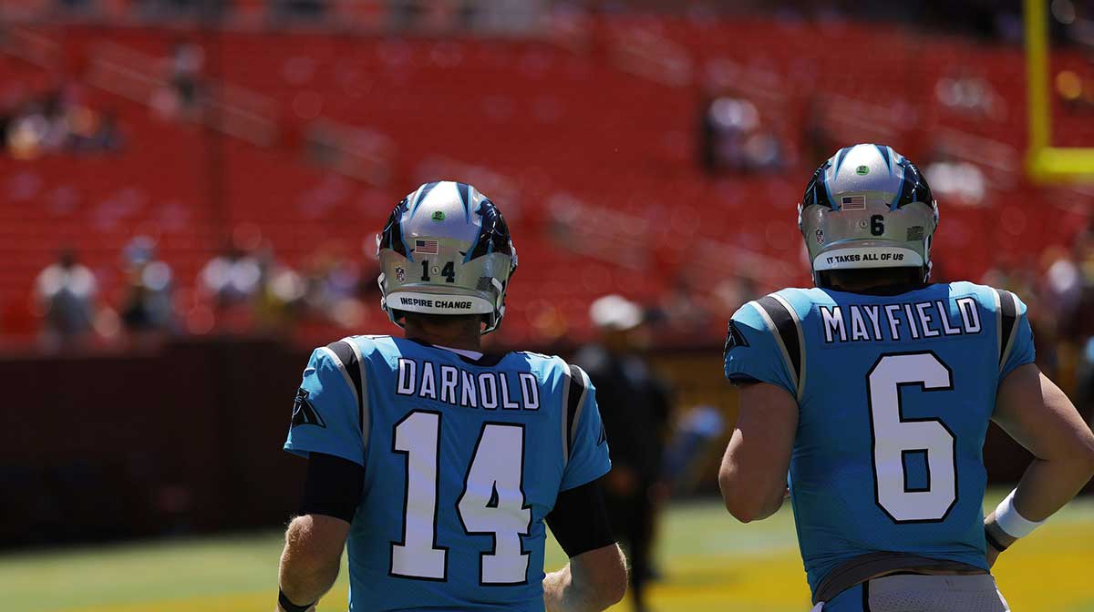 Carolina Panthers quarterback Sam Darnold (14) and Panthers quarterback Baker Mayfield (6) jog onto the field for warmups prior to the game against the Washington Commanders at FedExField.