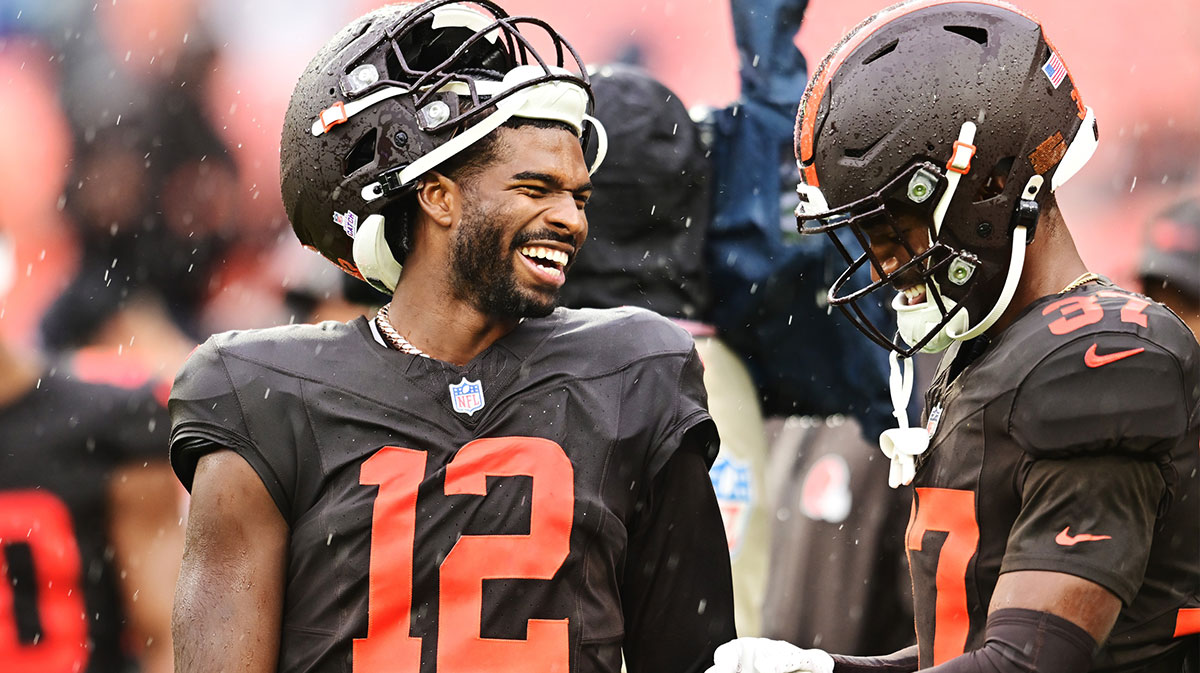 Cleveland Browns quarterback Shedeur Sanders (12) and cornerback Dom Jones (37) laugh before the game between the Browns and the Miami Dolphins at Huntington Bank Field.