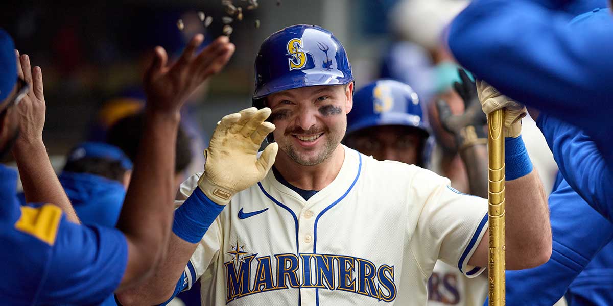 Seattle Mariners catcher Cal Raleigh (29) is greeted in the dugout after hitting a two-run home against the Los Angeles Angels in the first inning at T-Mobile Park.