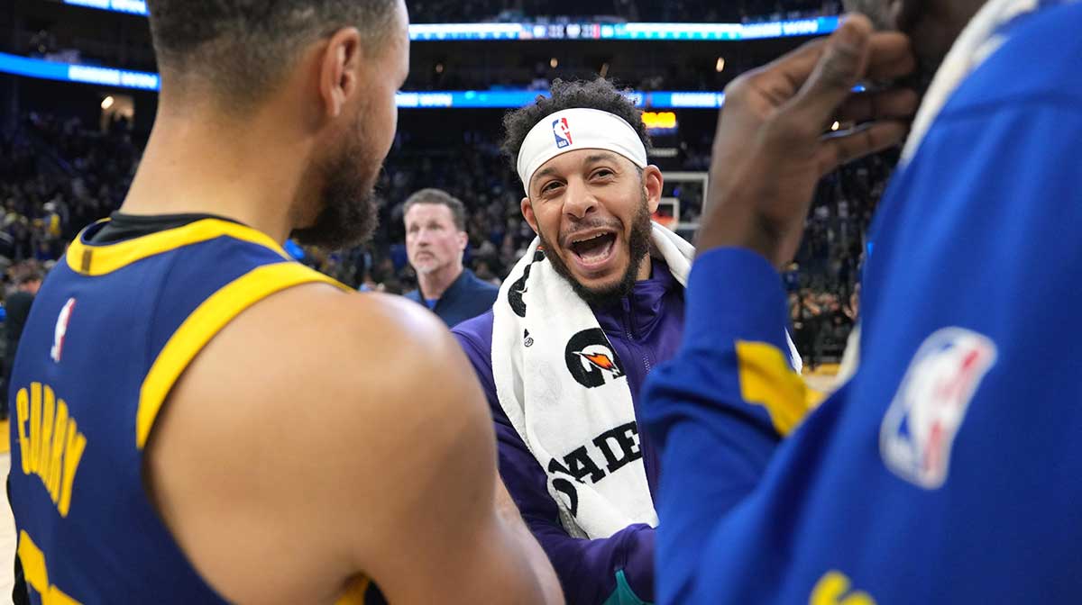 Charlotte Hornets guard Seth Curry (center) talks with Golden State Warriors guard Stephen Curry (left) and forward Draymond Green (right) after the game at Chase Center.