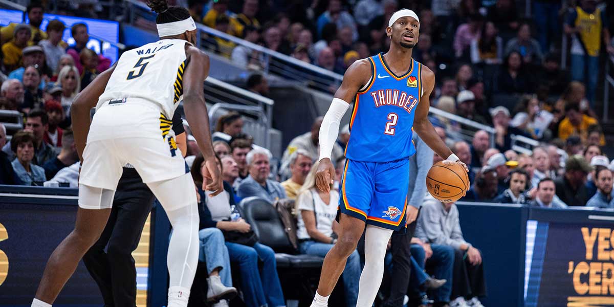 Oklahoma City Thunder guard Shai Gilgeous-Alexander (2) dribbles the ball while Indiana Pacers forward Jarace Walker (5) defends in the first half at Gainbridge Fieldhouse.
