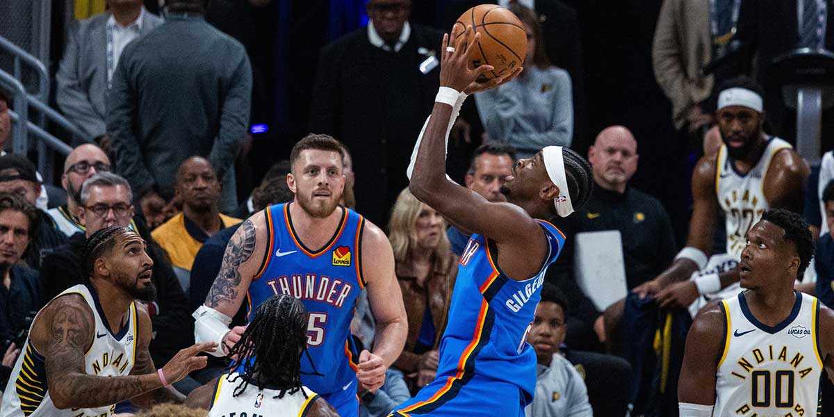 Oklahoma City Thunder guard Shai Gilgeous-Alexander (2) shoots the ball while Indiana Pacers guard Aaron Nesmith (23) defends in the first half at Gainbridge Fieldhouse.