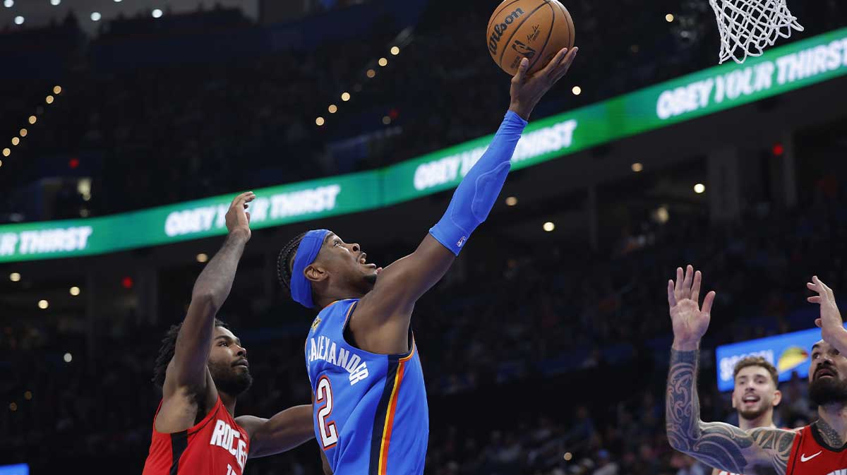 Oklahoma City Thunder guard Shai Gilgeous-Alexander (2) goes up for a basket between Houston Rockets forward Tari Eason (17) and center Steven Adams (12) during the first half at Paycom Center.