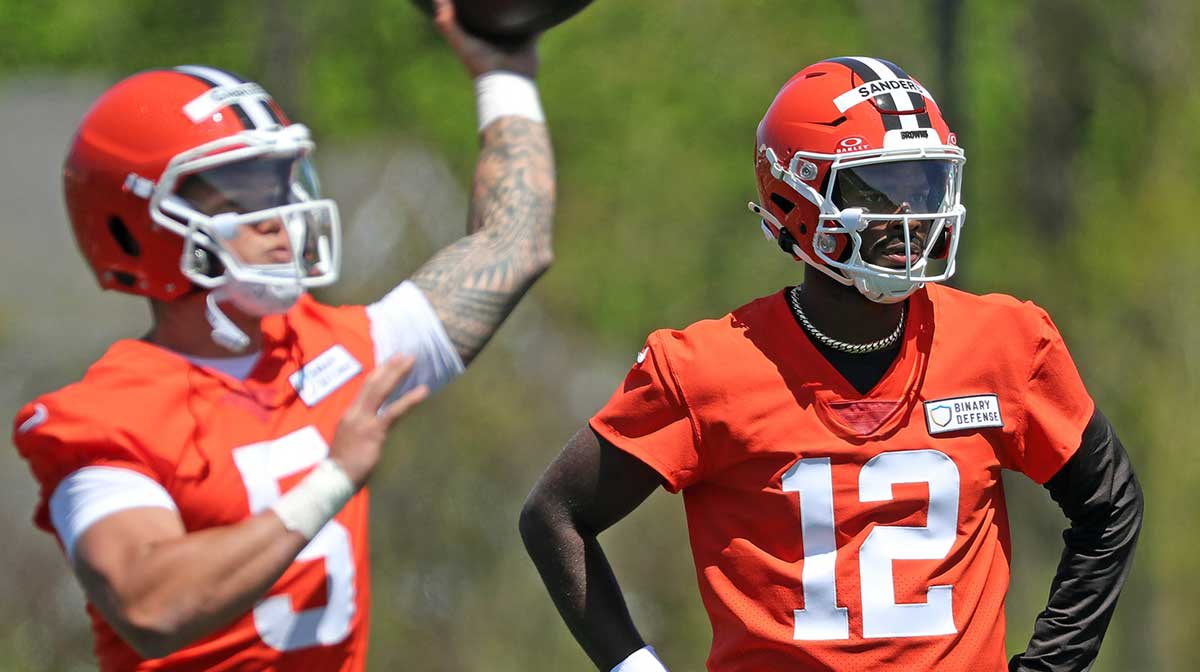 Cleveland Browns quarterback Shedeur Sanders (12) watches as quarterback Dillon Gabriel (5) throws during NFL rookie minicamp at the Cleveland Browns training facility on Friday, May 9, 2025, in Berea, Ohio.
