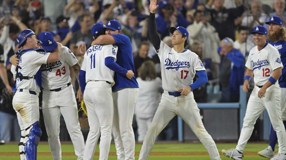 Los Angeles Dodgers two-way player Shohei Ohtani (17) celebrates with teammates after winning game four of the NLCS round against the Milwaukee Brewers for the 2025 MLB playoffs at Dodger Stadium.
