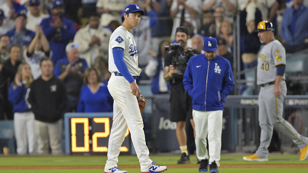 Los Angeles Dodgers two-way player Shohei Ohtani (17) reacts as manager Dave Roberts (30) walks out to the mound during the seventh inning of game four of the NLCS round against the Milwaukee Brewers for the 2025 MLB playoffs at Dodger Stadium.