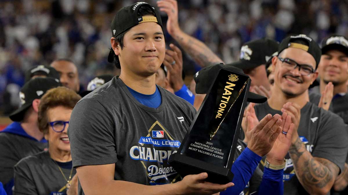 Los Angeles Dodgers two-way player Shohei Ohtani (17) holds the MVP trophy after defeating the Milwaukee Brewers in game five of the NLCS during the 2025 MLB playoffs at Dodger Stadium.