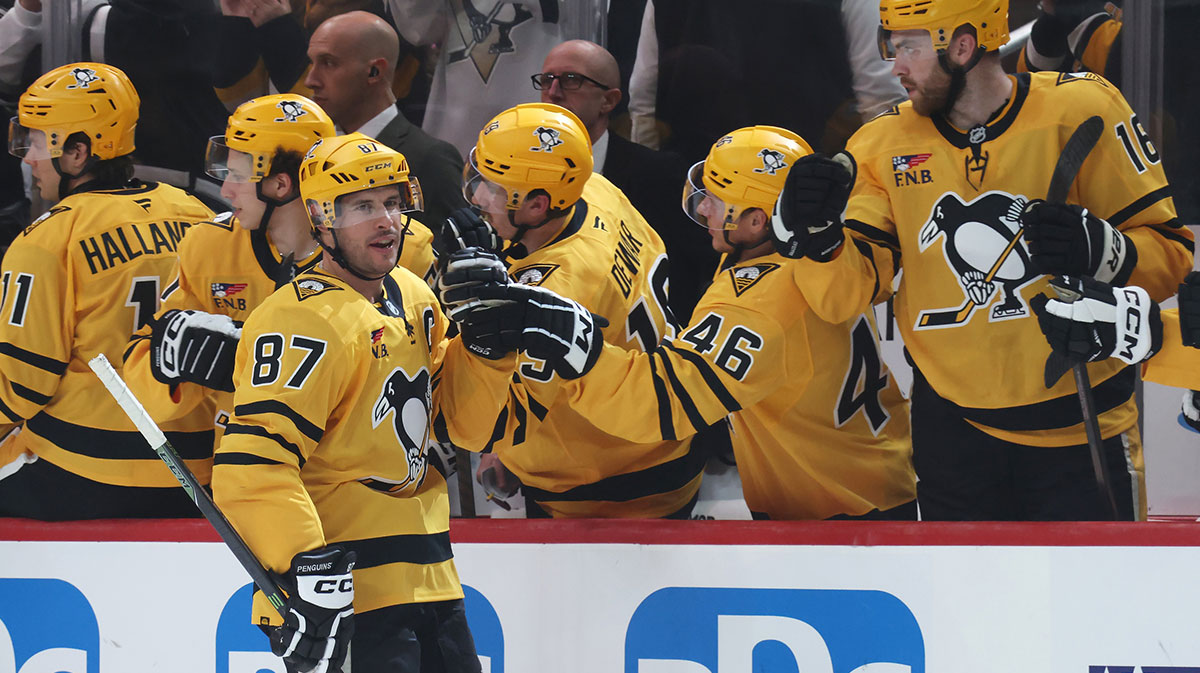 Pittsburgh Penguins center Sidney Crosby (87) celebrates his goal with the Penguins bench against the New York Islanders during the second period at PPG Paints Arena.