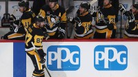 Pittsburgh Penguins center Sidney Crosby (87) celebrates with the Penguins bench after scoring a goal against the Vancouver Canucks during the second period at PPG Paints Arena.