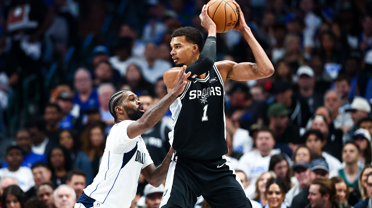 San Antonio Spurs forward Victor Wembanyama (1) looks to score as Dallas Mavericks forward Naji Marshall (13) defends during the first half at American Airlines Center.