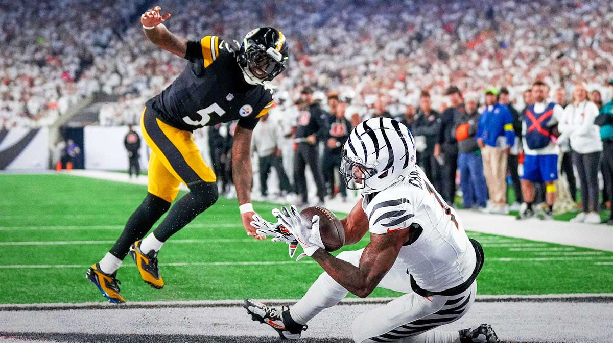 Cincinnati Bengals wide receiver Ja'Marr Chase (1) catches a pass under pressure from Pittsburgh Steelers cornerback Jalen Ramsey (5) for a touchdown in the second quarter of the NFL Week 7 game between the Cincinnati Bengals and the Pittsburgh Steelers at Paycor Stadium in downtown Cincinnati on Thursday, Oct. 16, 2025.