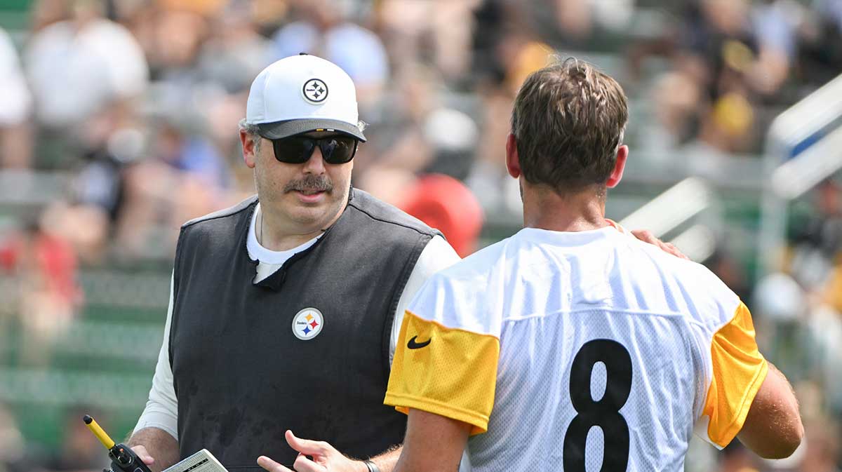 Pittsburgh Steelers offensive coordinator Arthur Smith talks with quarterback Aaron Rodgers (8) during drills at training camp at Saint Vincent College.