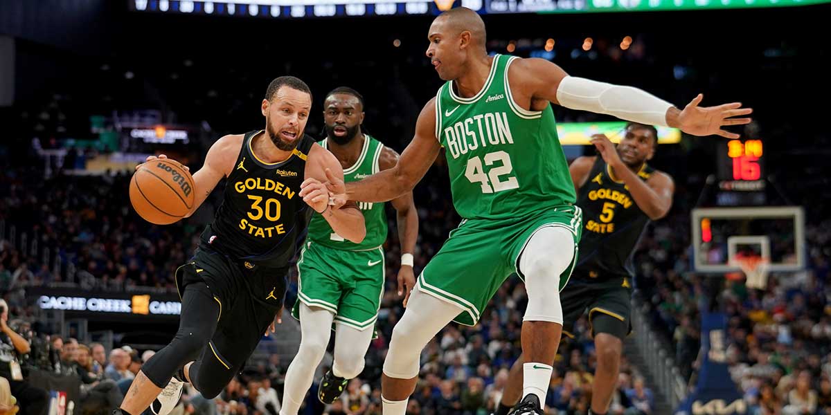 Warriors guard Stephen Curry (30) dribbles the ball next to Boston Celtics center Al Horford (42) in the third quarter at the Chase Center