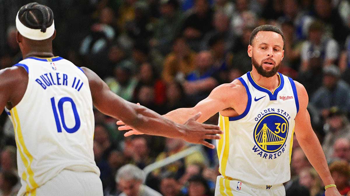 Golden State Warriors guard Stephen Curry (30) reacts with forward Jimmy Butler (10) after scoring a basket in the 3rd quarter against the Milwaukee Bucks at Fiserv Forum. Stephen Curry and Jimmy Butler on Oct. 30, 2025.