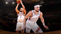 Suns guard Devin Booker in a defensive stance, while there's another photo of Devin Booker shooting a basketball next to him and a background of the Suns home arena.