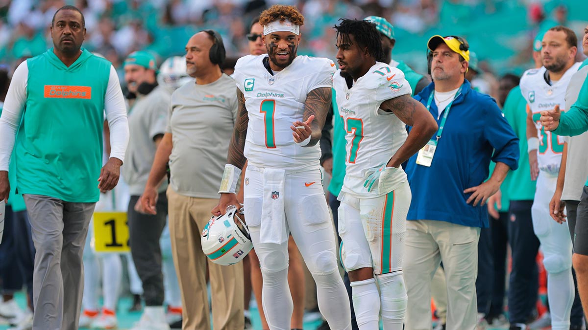 Miami Dolphins quarterback Tua Tagovailoa (1) talks to wide receiver Jaylen Waddle (17) on the sideline against the New England Patriots during the second quarter at Hard Rock Stadium.