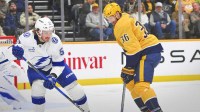 Nashville Predators left wing Cole Smith (36) and Tampa Bay Lightning defenseman Charle-Edouard D'Astous (51) battle for the puck during the second period at Bridgestone Arena.
