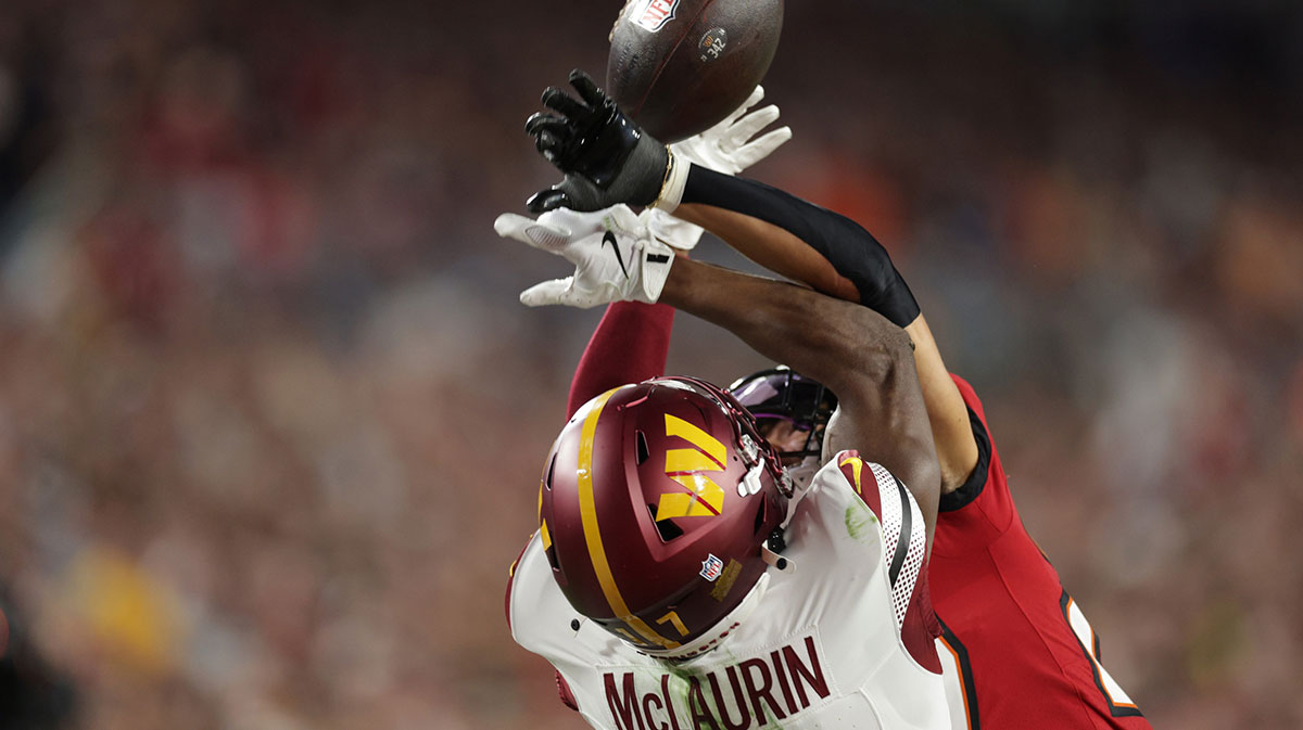Tampa Bay Buccaneers cornerback Zyon McCollum (27) breaks up a pass intended for Washington Commanders wide receiver Terry McLaurin (17) during the second quarter of a NFC wild card playoff at Raymond James Stadium.