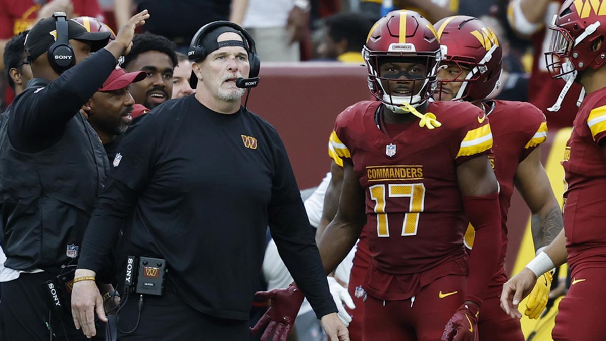 Washington Commanders head coach Dan Quinn (L) stands with Commanders wide receiver Terry McLaurin (17) on the sidelines against the Las Vegas Raiders during the third quarter at Northwest Stadium.
