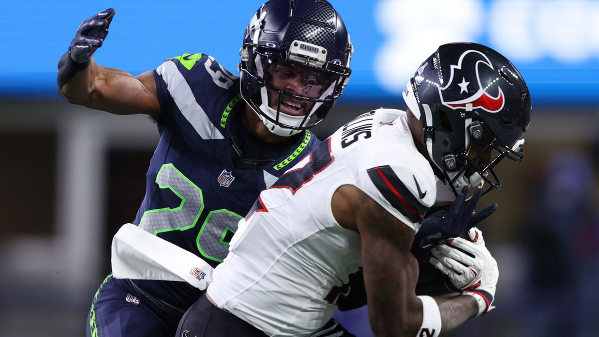 Seattle Seahawks cornerback Josh Jobe (29) tackles Houston Texans wide receiver Nico Collins (12) during the second quarter at Lumen Field.