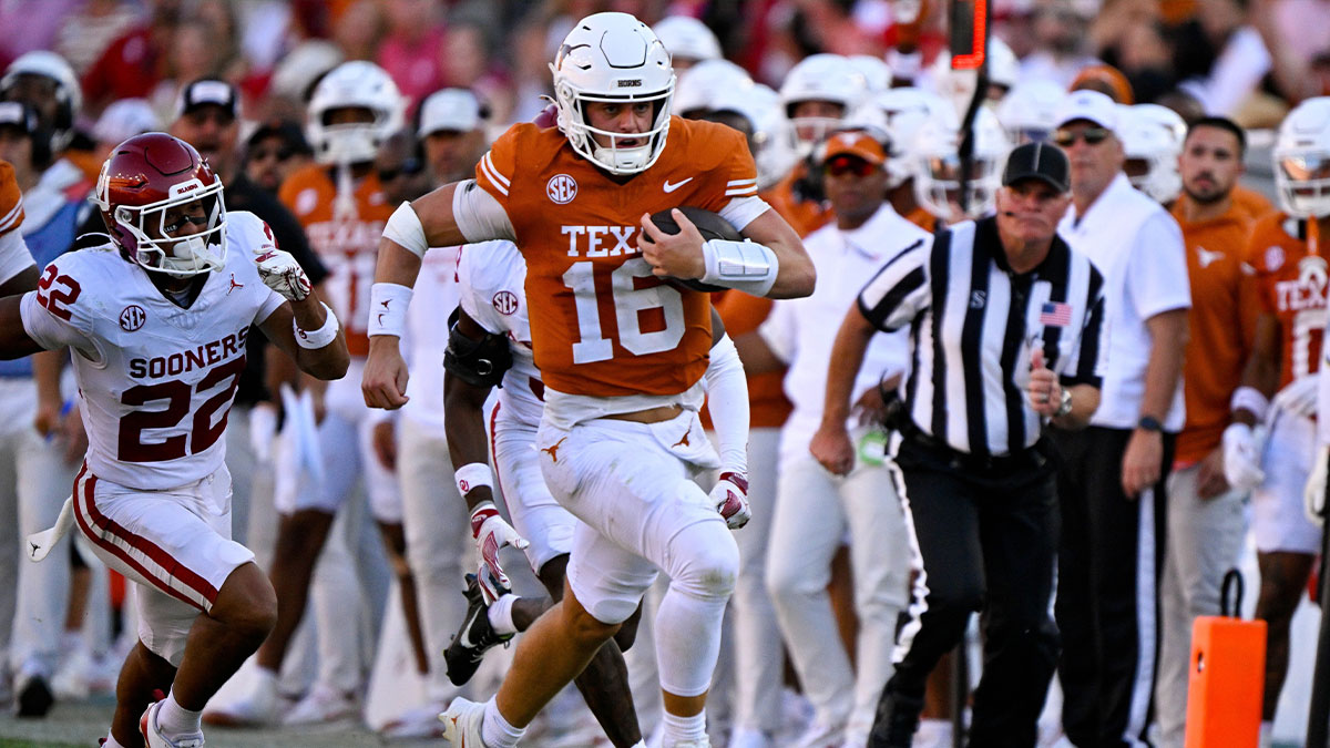 Texas Longhorns quarterback Arch Manning (16) runs for a first down against the Oklahoma Sooners during the second half at the Cotton Bowl.