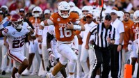 Texas Longhorns quarterback Arch Manning (16) runs for a first down against the Oklahoma Sooners during the second half at the Cotton Bowl.