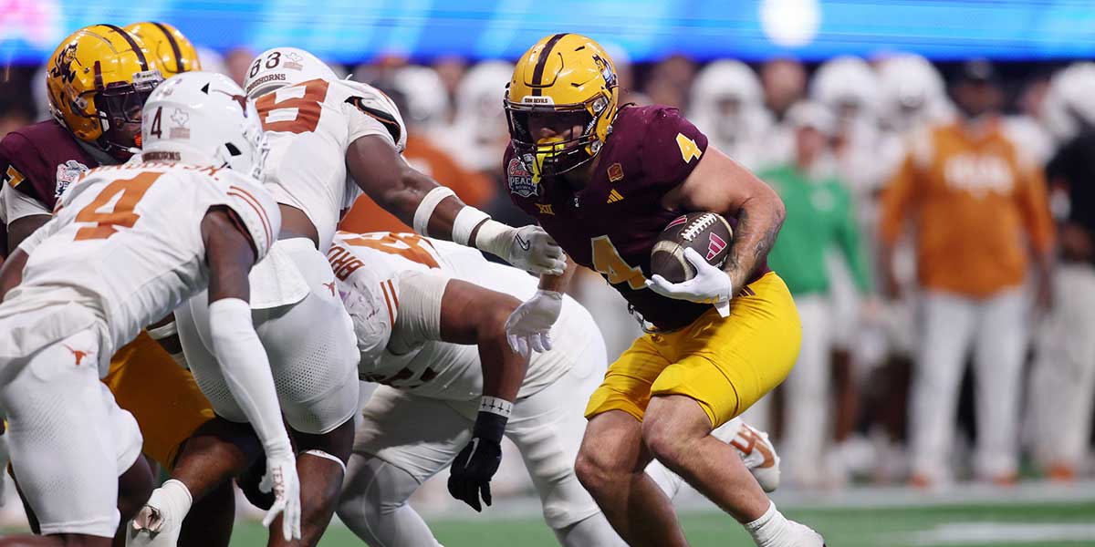 Texas Longhorns running back CJ Baxter (4) runs with the ball against the Texas Longhorns during the second half of the Peach Bowl at Mercedes-Benz Stadium.