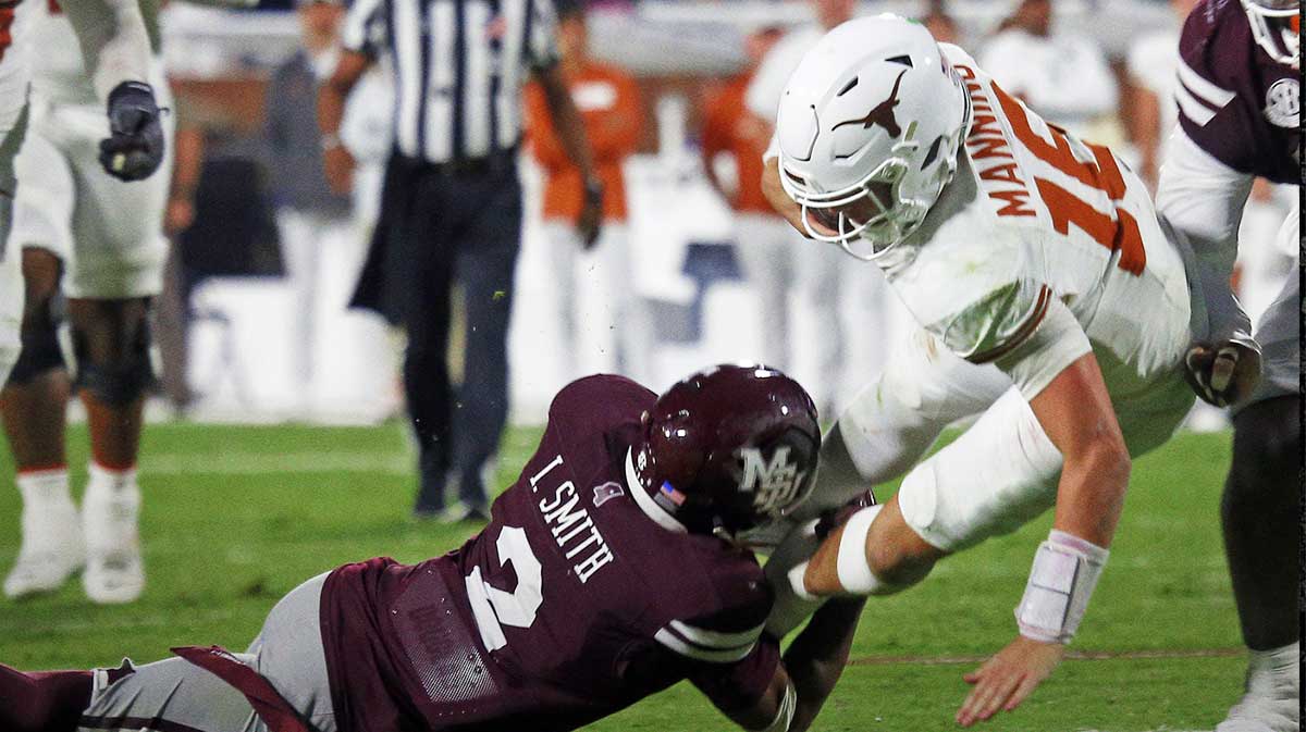 Texas Longhorns quarterback Arch Manning (16) runs the ball as Mississippi State Bulldogs defensive back Isaac Smith (2) makes the tackle during overtime at Davis Wade Stadium at Scott Field.
