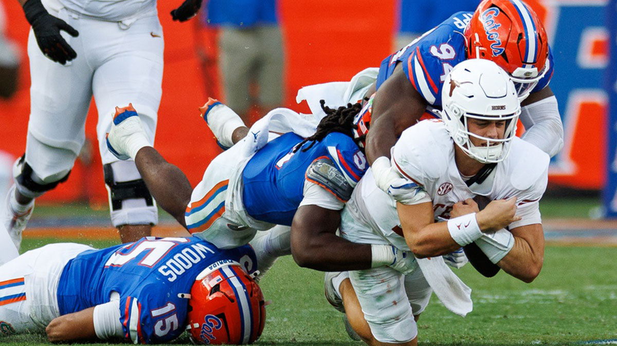 Florida Gators defensive end Tyreak Sapp (94) and linebacker Myles Graham (5) sack Texas Longhorns quarterback Arch Manning (16) during the second half at Ben Hill Griffin Stadium. 