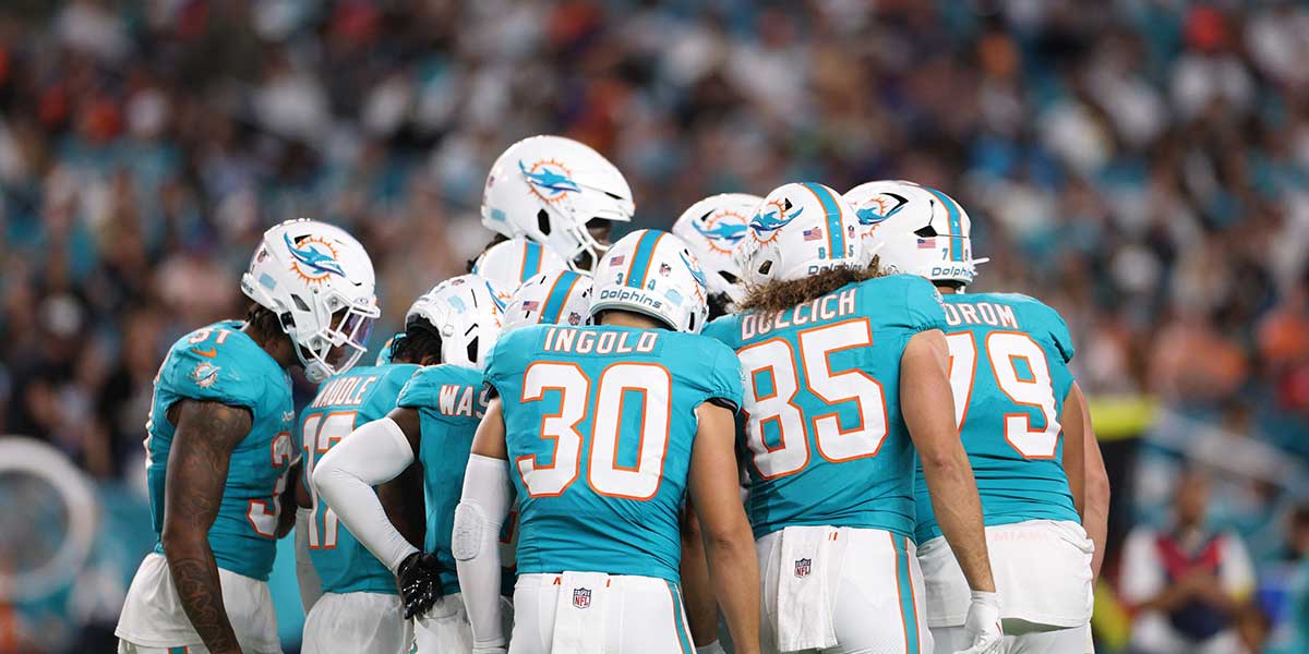The Miami Dolphins huddle during the second quarter against the Baltimore Ravens at Hard Rock Stadium.
