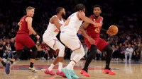 Cleveland Cavaliers guard Donovan Mitchell (45) controls the ball against New York Knicks guards Jalen Brunson (11) and Mikal Bridges (25) during the first quarter at Madison Square Garden.