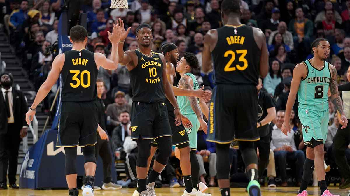 Golden State Warriors forward Jimmy Butler III (10) is congratulated by guard Stephen Curry (30) after a basket against the Charlotte Hornets in the third quarter at the Chase Center.