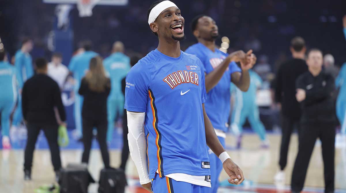 Thunder guard Shai Gilgeous-Alexander smiles during warm ups before a game between the Charlotte Hornets and the Oklahoma City Thunder at Paycom Center