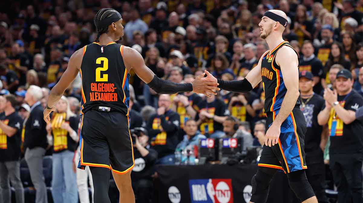 Thunder guard Shai Gilgeous-Alexander (2) and guard Alex Caruso (9) high five after a play against the Denver Nuggets during the second half during game one of the second round for the 2025 NBA Playoffs at Paycom Center