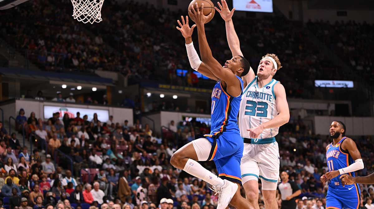 Thunder guard Aaron Wiggins (21) drives the basket against the Charlotte Hornets at North Charleston Coliseum