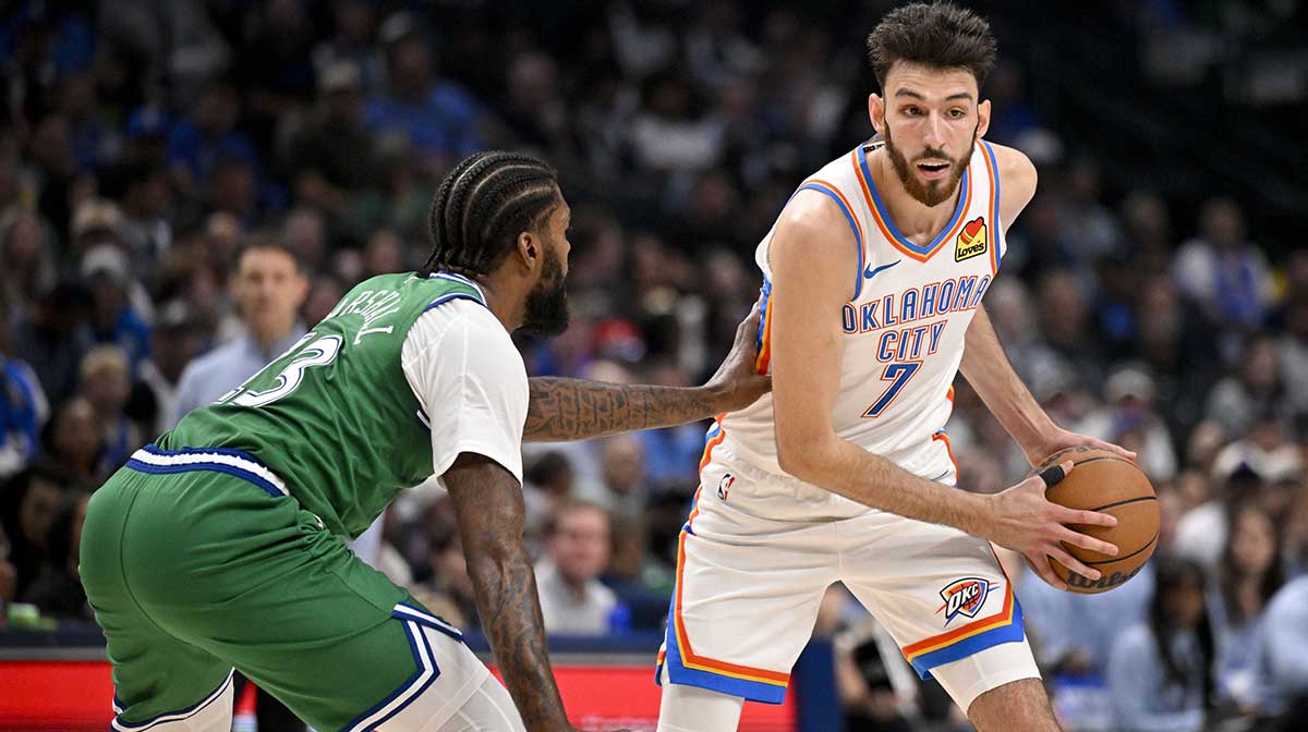 Thunder center Chet Holmgren (7) looks to move the ball past Dallas Mavericks forward Naji Marshall (13) during the second quarter at the American Airlines Center