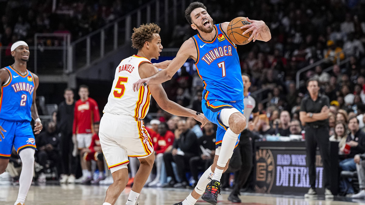 Thunder center Chet Holmgren (7) is fouled by Atlanta Hawks guard Dyson Daniels (5) during the second half at State Farm Arena