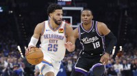 Thunder guard Ajay Mitchell (25) drives past Sacramento Kings guard Russell Westbrook (18) during the second half at Paycom Center with Thunder head coach Mark Daigneault in the background