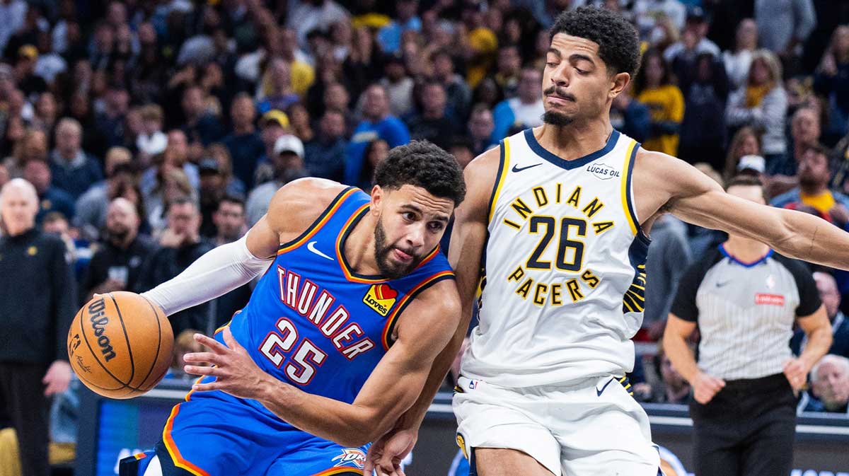 Thunder guard Ajay Mitchell (25) dribbles the ball while Indiana Pacers guard Ben Sheppard (26) defends in the second half at Gainbridge Fieldhouse