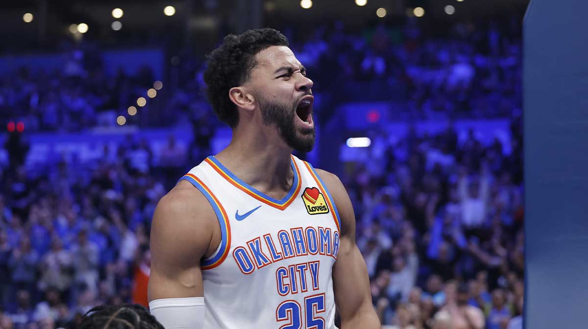 Thunder guard Ajay Mitchell (25) celebrates after scoring against the Sacramento Kings during the second half at Paycom Center with Sports Illustrated's Chris Mannix in the background
