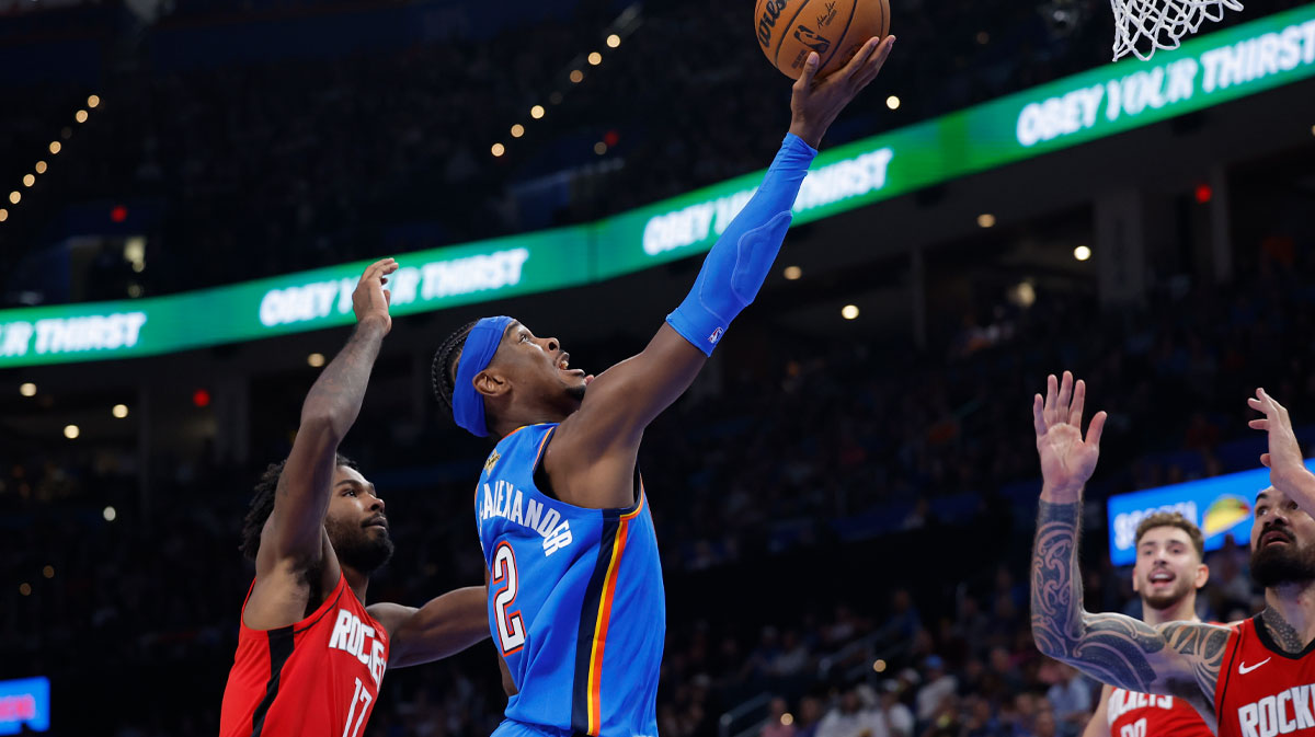 Oklahoma City Thunder guard Shai Gilgeous-Alexander (2) goes up for a basket between Houston Rockets forward Tari Eason (17) and center Steven Adams (12) during the first half at Paycom Center.
