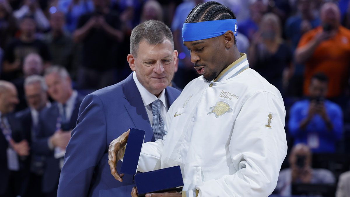 Thunder guard Shai Gilgeous-Alexander looks at his championship ring