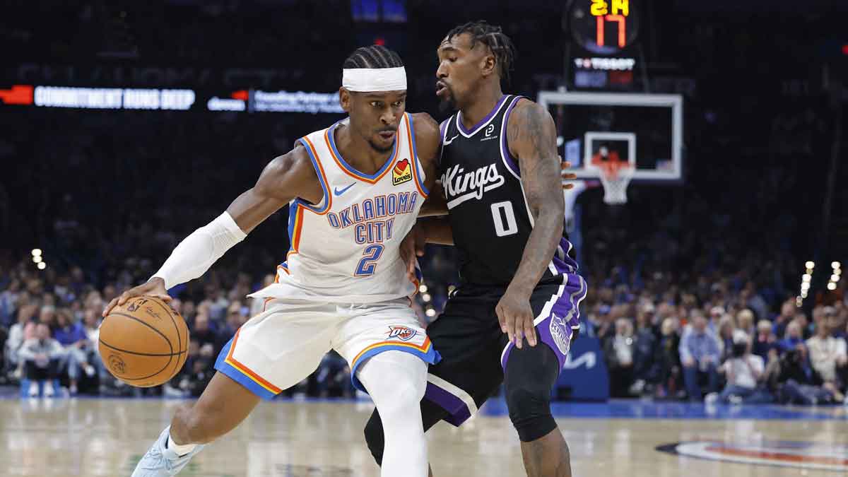 Oklahoma City Thunder guard Shai Gilgeous-Alexander (2) drives past Sacramento Kings guard Malik Monk (0) during the second half at Paycom Center.