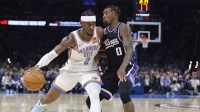 Oklahoma City Thunder guard Shai Gilgeous-Alexander (2) drives past Sacramento Kings guard Malik Monk (0) during the second half at Paycom Center.