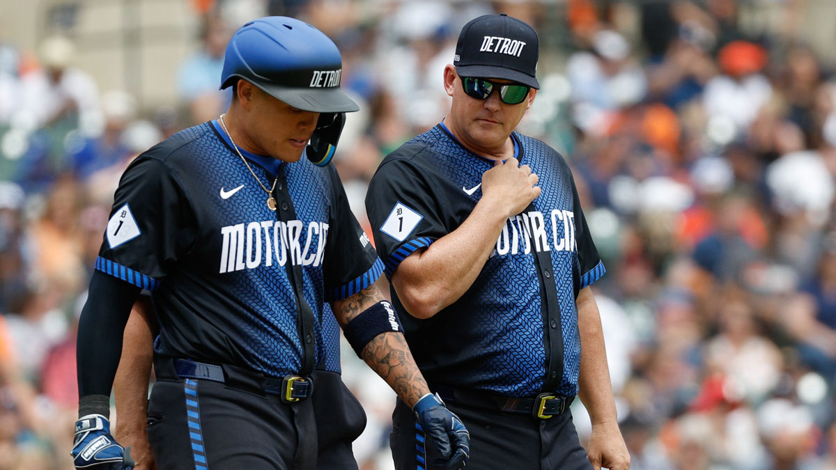 Detroit Tigers manager AJ Hinch checks with Detroit Tigers third baseman Gio Urshela (13) after he was hit by a pitch in the eighth inning of the game against the Toronto Blue Jays at Comerica Park.