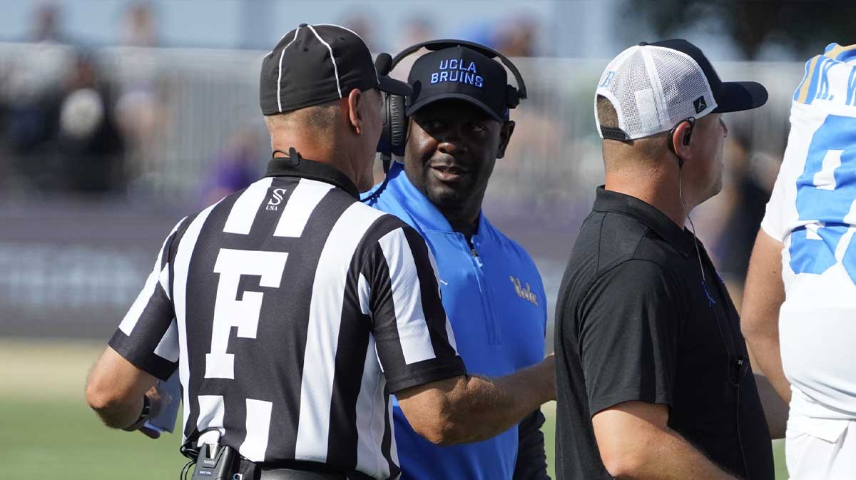 UCLA Bruins interim head coach Tim Skipper talks to a official during the first half against the Northwestern Wildcats during the first half at Northwestern Medicine Field at Martin Stadium.