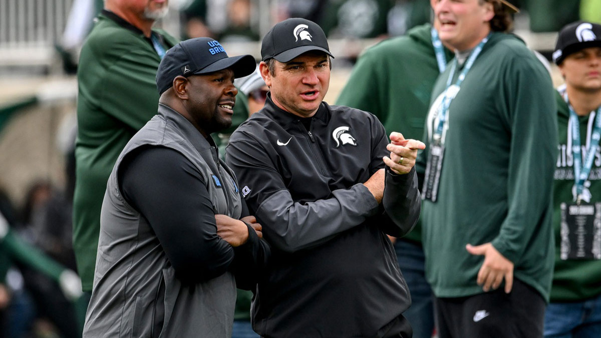 Michigan State's head coach Jonathan Smith, right, talks with UCLA's interim head coach Tim Skipper before the football game on Saturday, Oct. 11, 2025, at Spartan Stadium in East Lansing.