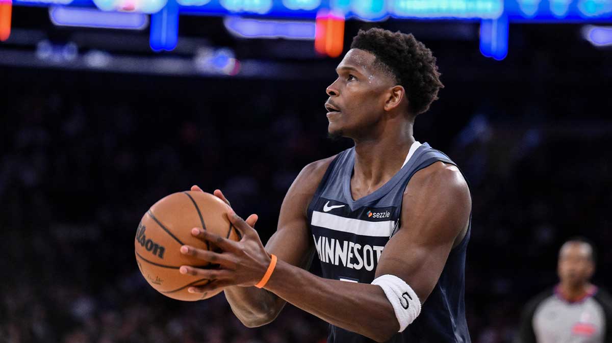 Timberwolves guard Anthony Edwards (5) shoots the ball against the New York Knicks during the first half at Madison Square Garden with ESPN's Shams Charania in the background