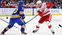 Buffalo Sabres defenseman Zach Metsa (73) tries to block a shot by Detroit Red Wings left wing Lucas Raymond (23) during the first period at KeyBank Center.